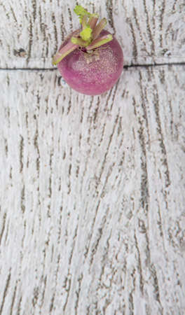 Small purple radish vegetable over wooden backgroundの写真素材