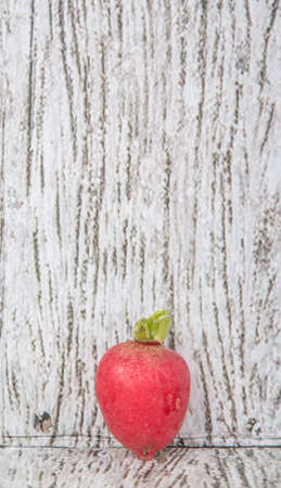 Small red radish vegetable over wooden backgroundの写真素材