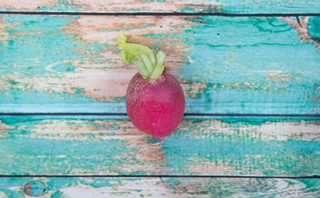 Small red radish vegetable over wooden backgroundの写真素材