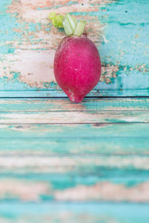 Small red radish vegetable over wooden backgroundの写真素材