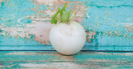 Small white radish vegetable over wooden backgroundの写真素材
