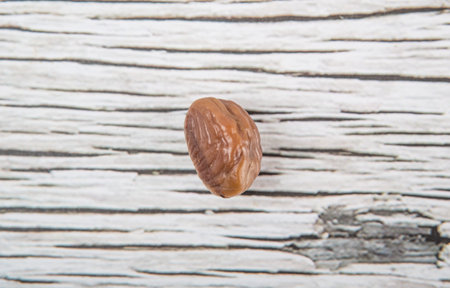 Roasted whole peeled chestnut over wooden background