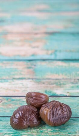 Roasted whole peeled chestnut over wooden backgroundの写真素材