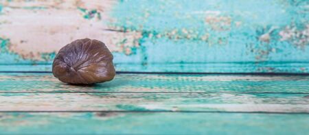 Roasted whole peeled chestnut over wooden backgroundの写真素材