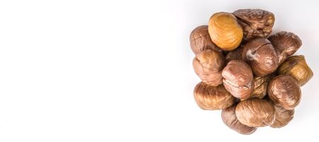 Roasted whole peeled chestnut over white backgroundの写真素材