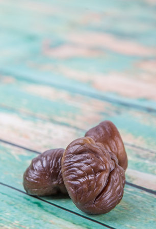 Roasted whole peeled chestnut over white background