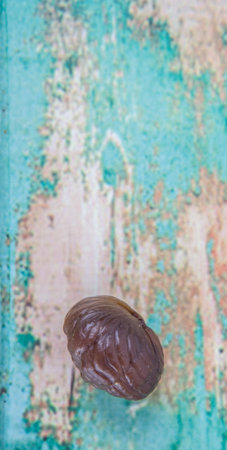 Roasted whole peeled chestnut over white backgroundの写真素材