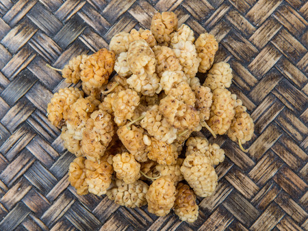 Dried white mulberry over wicker backgroundの写真素材