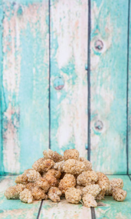 Dried white mulberry over wooden backgroundの写真素材