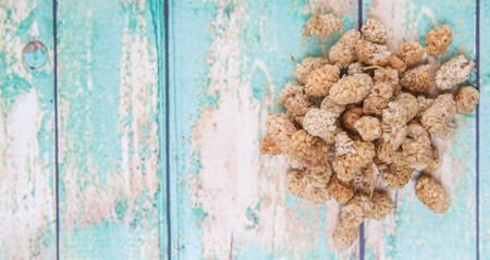 Dried white mulberry over wooden backgroundの写真素材