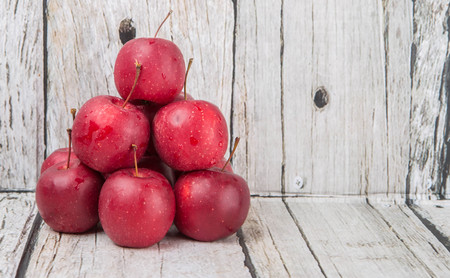 Crab apple fruit over wooden backgroundの写真素材