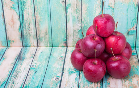Crab apple fruit over wooden backgroundの写真素材
