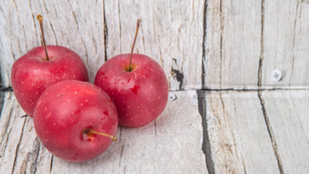 Crab apple fruit over wooden backgroundの写真素材