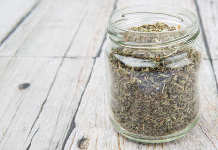 Dried lemon balm leaves in mason jar over wooden backgroundの写真素材