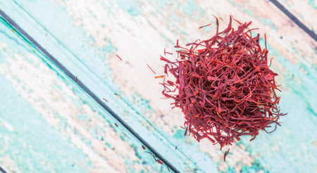 Dried saffron spices over wooden background