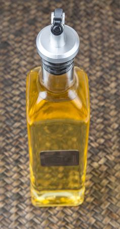 Vegetable cooking oil over wicker backgroundの写真素材
