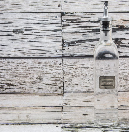 White vinegar over wooden backgroundの写真素材
