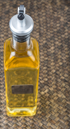 Vegetable cooking oil over wicker backgroundの写真素材