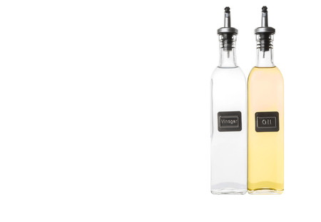 Vegetable cooking oil and white vinegar in a glass bottles over white backgroundの写真素材