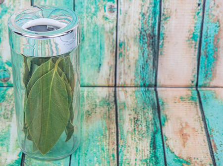 Dried laurel leaves over wooden backgroundの写真素材