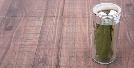 Dried laurel leaves over wooden backgroundの写真素材