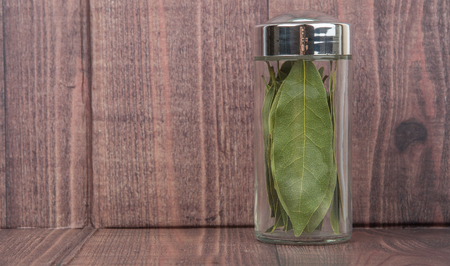 Dried laurel leaves over wooden backgroundの写真素材