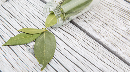 Dried laurel leaves over wooden backgroundの写真素材