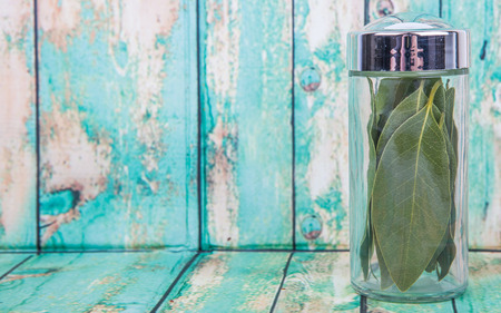 Dried laurel leaves herb over wooden backgroundの写真素材