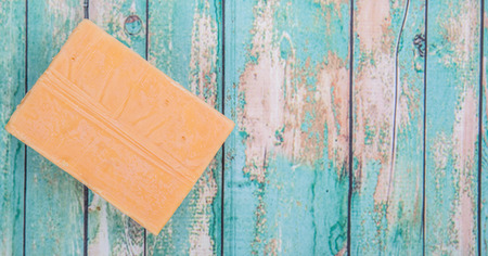 A block of cheddar cheese over wooden backgroundの写真素材