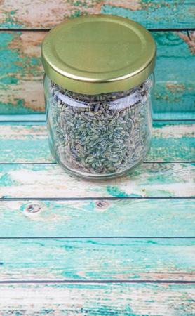 Dried lavender herbal tea in mason jar over wooden backgroundの写真素材