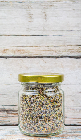 Dried lavender herbal tea in mason jar over wooden backgroundの写真素材