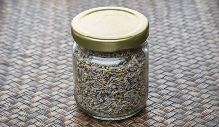 Dried lavender herb tea in mason jar over wicker backgroundの写真素材