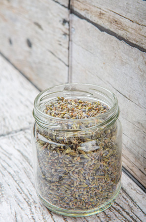 Dried lavender herbal tea in mason jar over wooden backgroundの写真素材