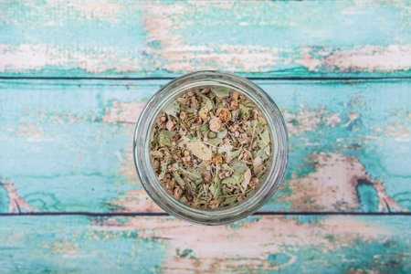 Dried linden flower herbal tea in mason jar over wooden backgroundの写真素材