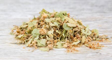 Dried linden flower herbal tea over wooden backgroundの写真素材