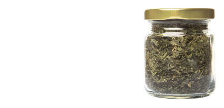 Dried Japanese tea leaves in mason jar over wooden backgroundの写真素材