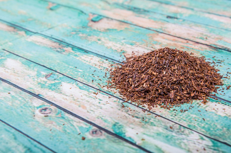 Dried rooibos herbal tea over wooden backgroundの写真素材