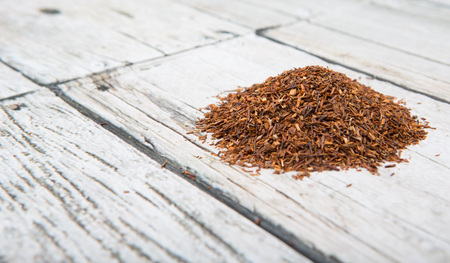 Dried rooibos herbal tea over wooden backgroundの写真素材