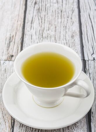 Japanese green tea in white cup over wooden backgroundの写真素材