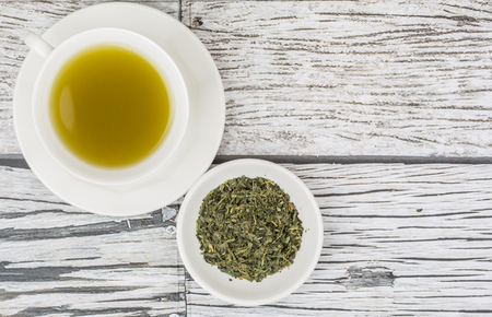 Japanese green tea in white cup over wooden backgroundの写真素材