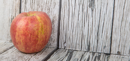 Fresh Japanese Fuji apple over wooden backgroundの写真素材