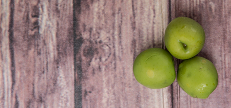 Pickled olive fruit over wooden backgroundの写真素材