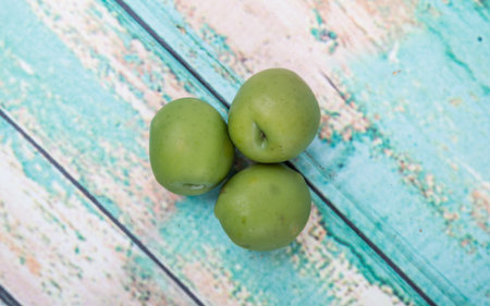 Pickled olive fruit over wooden backgroundの写真素材