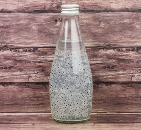 Sweet basil seed drink  over wooden backgroundの写真素材
