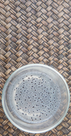 Sweet basil seed drink in a bottle over wooden background
