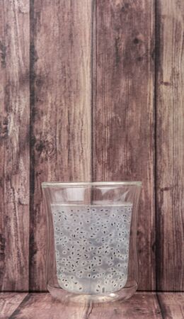 Sweet basil seed drink in a bottle over wooden backgroundの写真素材