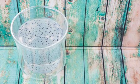 Sweet basil seed drink in a bottle over wooden backgroundの写真素材