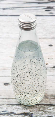 Sweet basil seed drink in a bottle over wooden backgroundの写真素材
