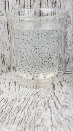 Sweet basil seed drink in a bottle over wooden backgroundの写真素材