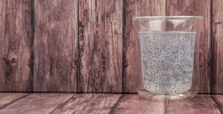 Sweet basil seed drink in a bottle over wooden backgroundの写真素材